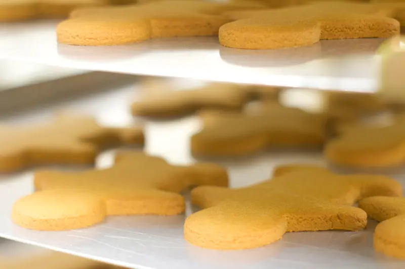 Freshly baked gingerbread cookies cooling on trays — contact Molly Woppy for artisan cookies, orders, and customer enquiries in New Zealand.