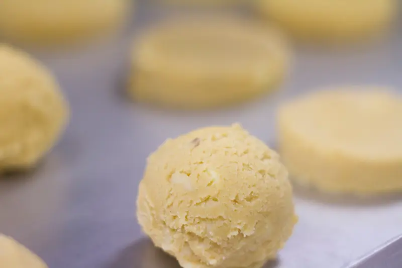Close-up of white chocolate cookie dough ball on baking tray — Molly Woppy award-winning cookies handmade in New Zealand.