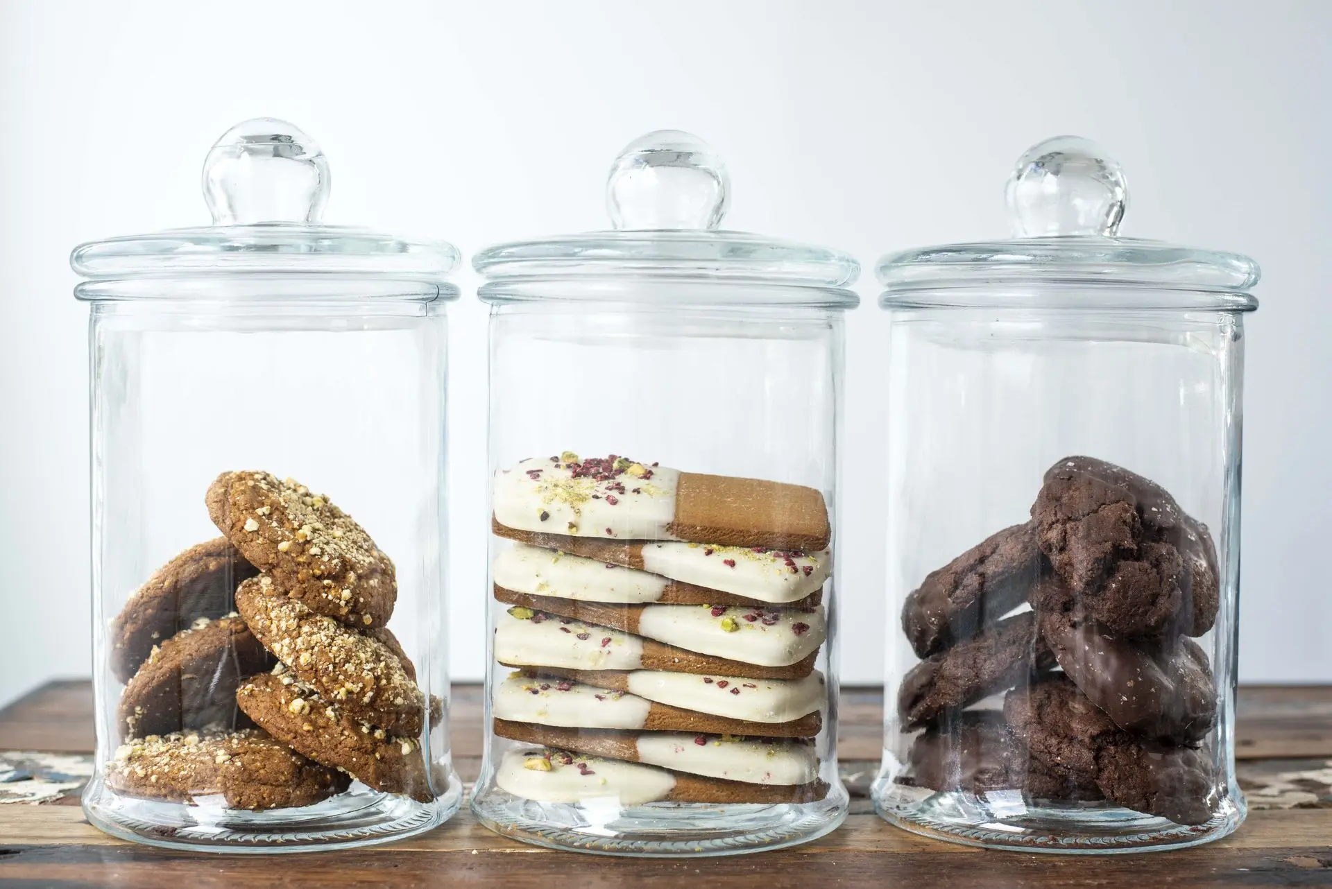 Glass jars filled with Molly Woppy artisan cookies — crunchy oat cookies, white chocolate dipped gingerbread, and rich chocolate cookies, ideal for corporate cookie gifting in New Zealand.