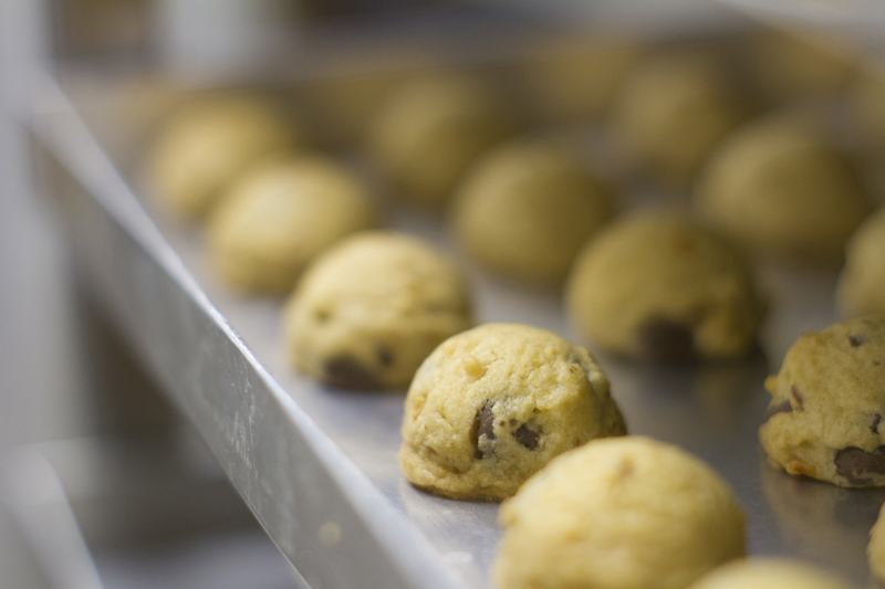Freshly scooped chocolate chip cookie dough portions lined on baking tray — Molly Woppy award-winning artisan cookies made in New Zealand.
